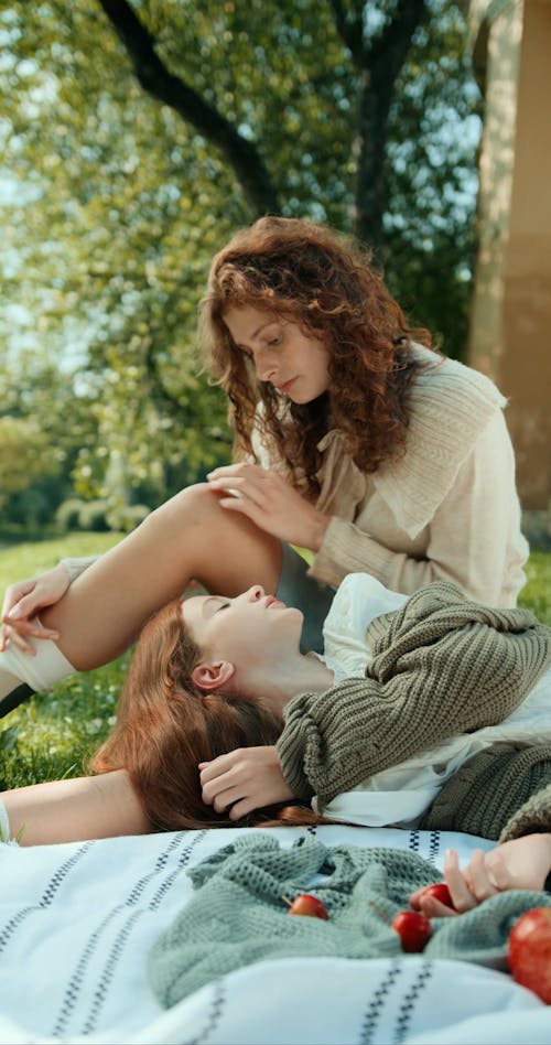 Young Women Having a Conversation at a Picnic