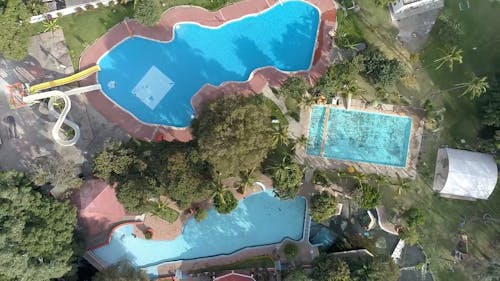 Aerial View on Swimming Pools around Trees