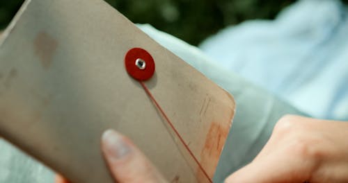 A Person Tying a Journal