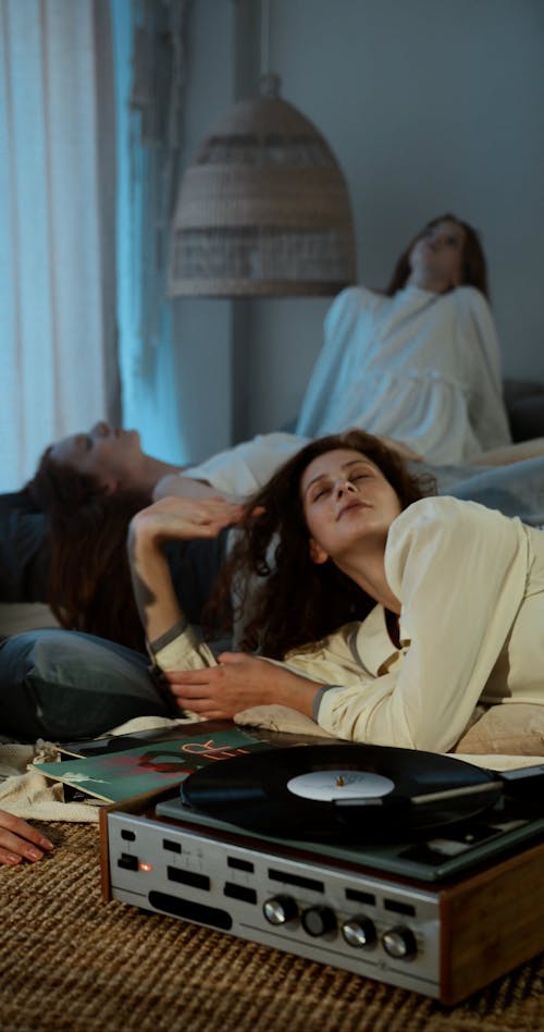 Women Listening to a Record Player in a Bedroom