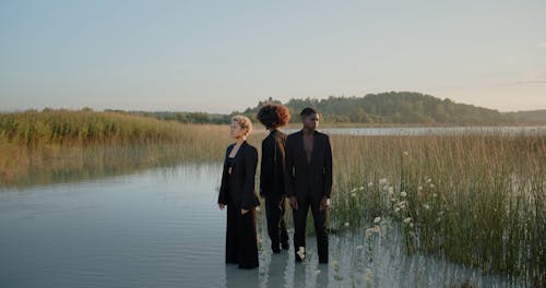 Woman Standing in Water with Men