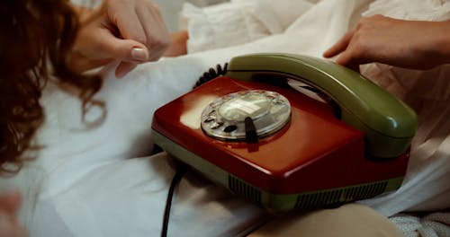 A Woman Making a Call on a Rotary Telephone
