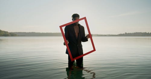 Man in Water Holding Frame