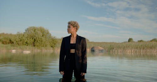 Woman in Suit Standing in Water