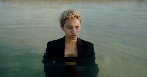 Woman in Suit Standing in Water