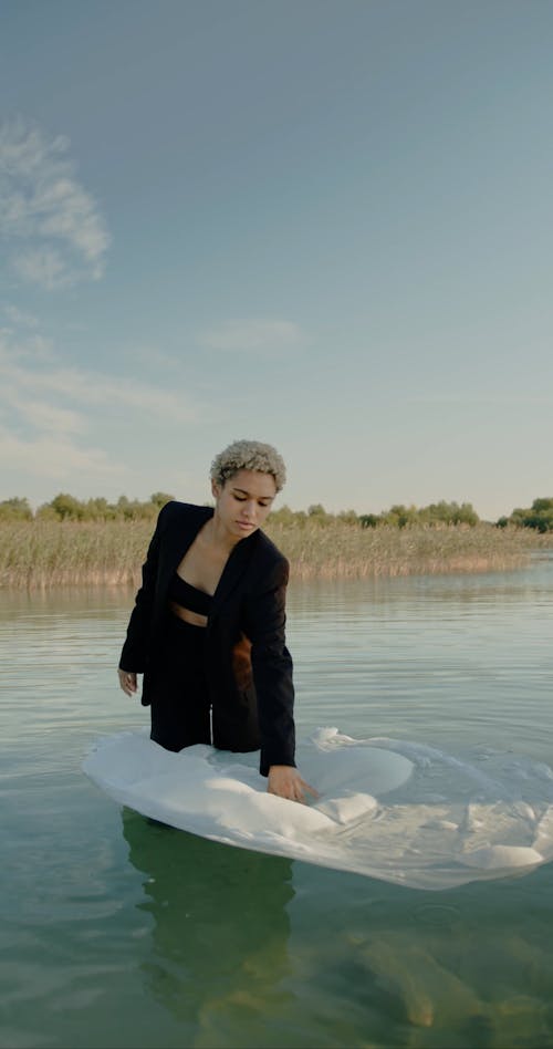 Woman Standing with Foil in Water