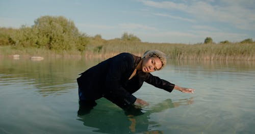 Woman in Suit Moving in Water