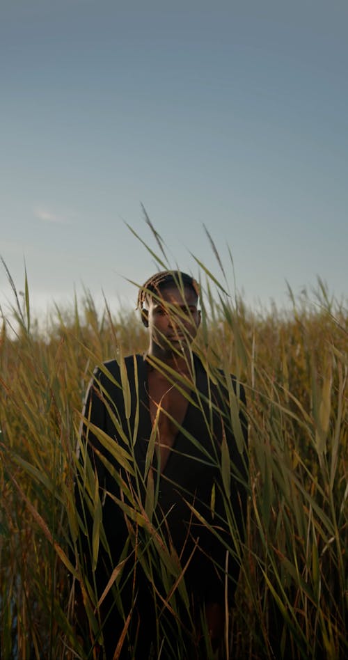 Man in Suit Standing in Rushes