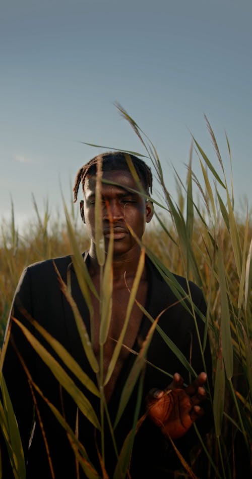 Man with Short Hair Standing in Rushes