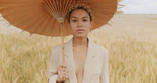 Portrait of Woman with Umbrella on Field