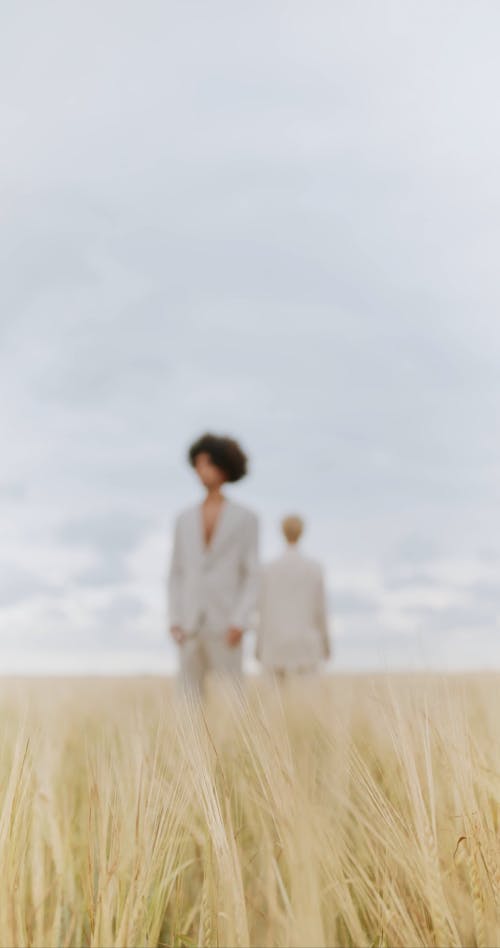 Woman and Man in Suits on Field