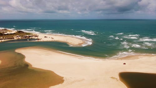 Aerial View of a Sandy Beach and a Coastal Town