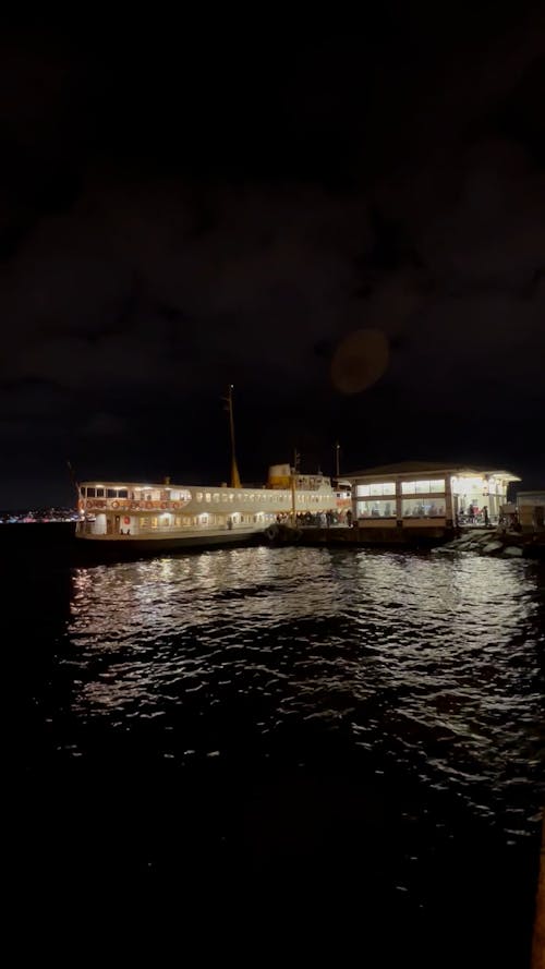 Passengers Disembarking from a Ferry Boat at Night