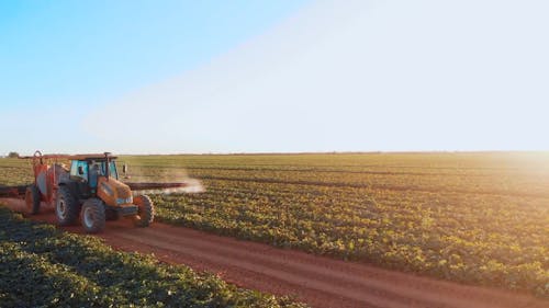 Tractor Watering Crops