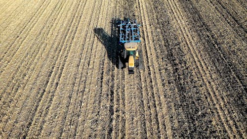 A Tractor Plowing the Cropland