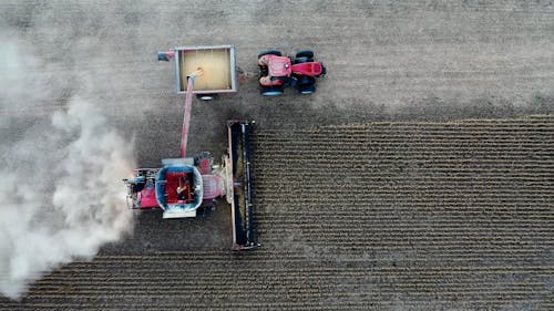 Drone Footage of a Farmer using a Tractor while Harvesting Crops