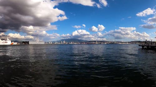 Time Lapse of Moving Clouds over a Coastal City