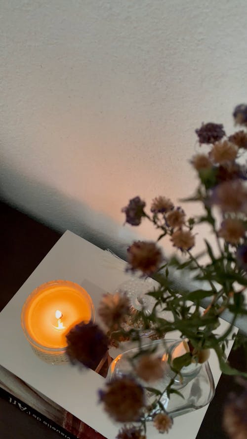 Close up on Flowers and Wax Candle