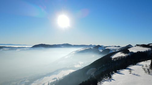 Drone View of a Snow Covered Mountain on a Sunny Day