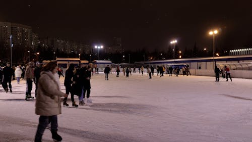 People Ice Skating at Night