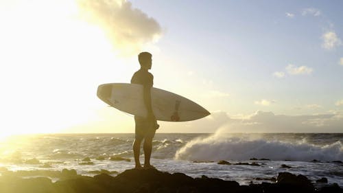 Man Holding A Surfboard