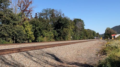 Train Moving Along Railroad Tracks