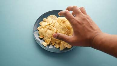 hand reaching for crisps