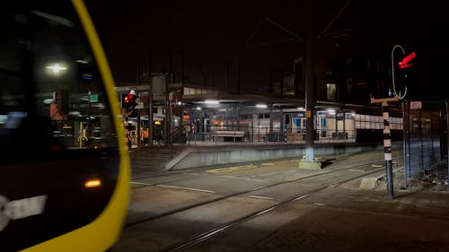 Moving Train and Bus Stop at Night