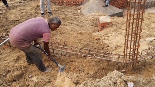 Construction Worker Digging with Shovel