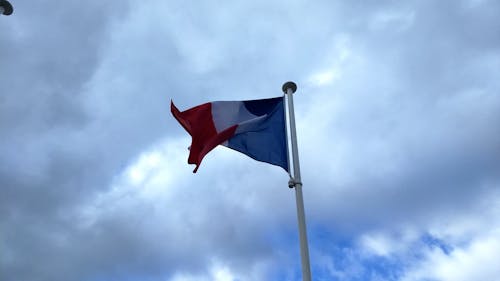 Flag of France Waving under the Blue Sky