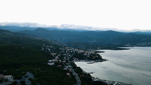 Aerial Footage of a Coastal Town and a Mountain Landscape 