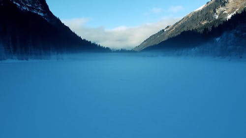 Drone Footage of a Frozen Lake in a Mountain Landscape