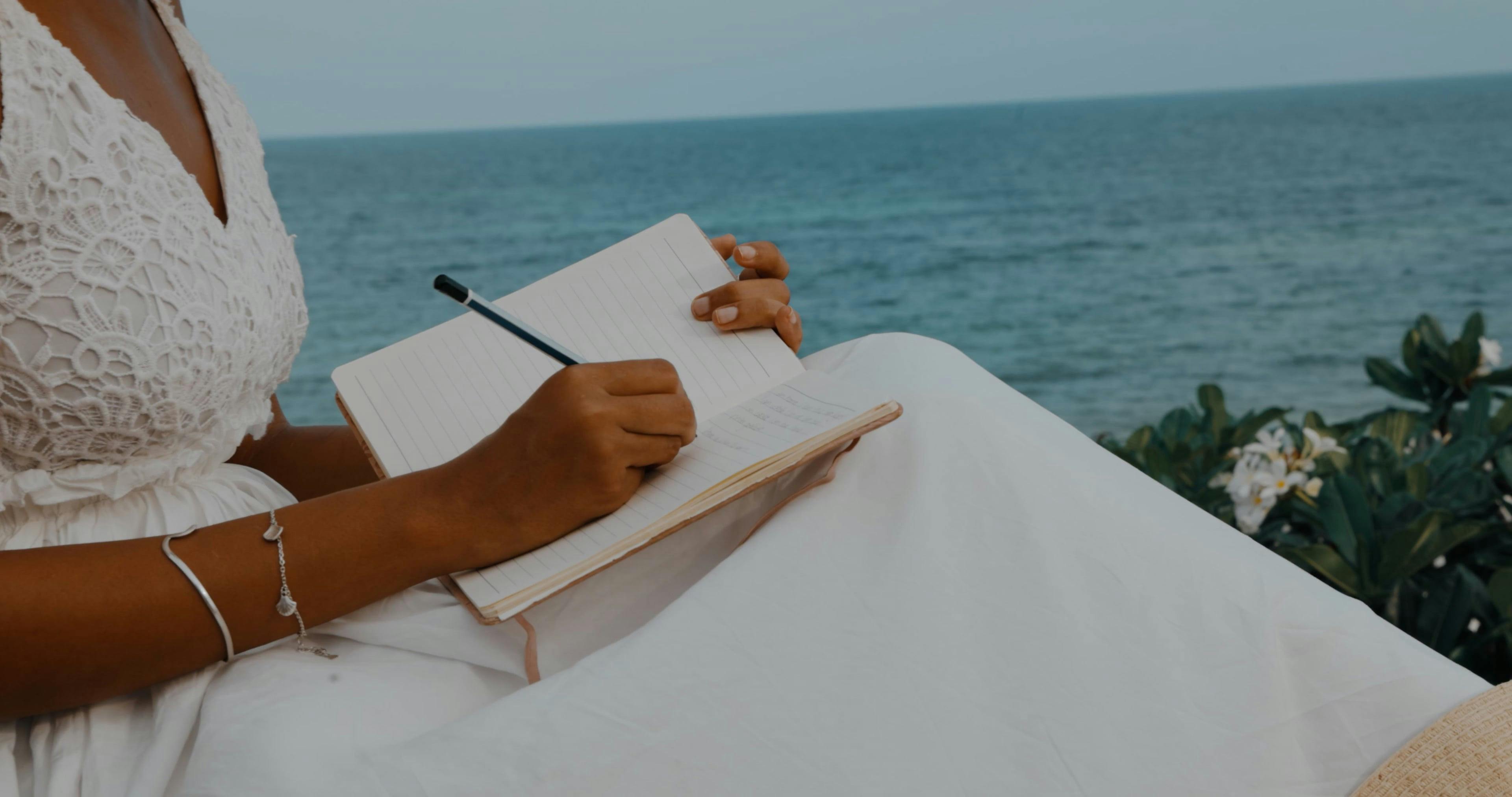 Woman Writing in Notebook on Seashore Free Stock Video Footage, Royalty