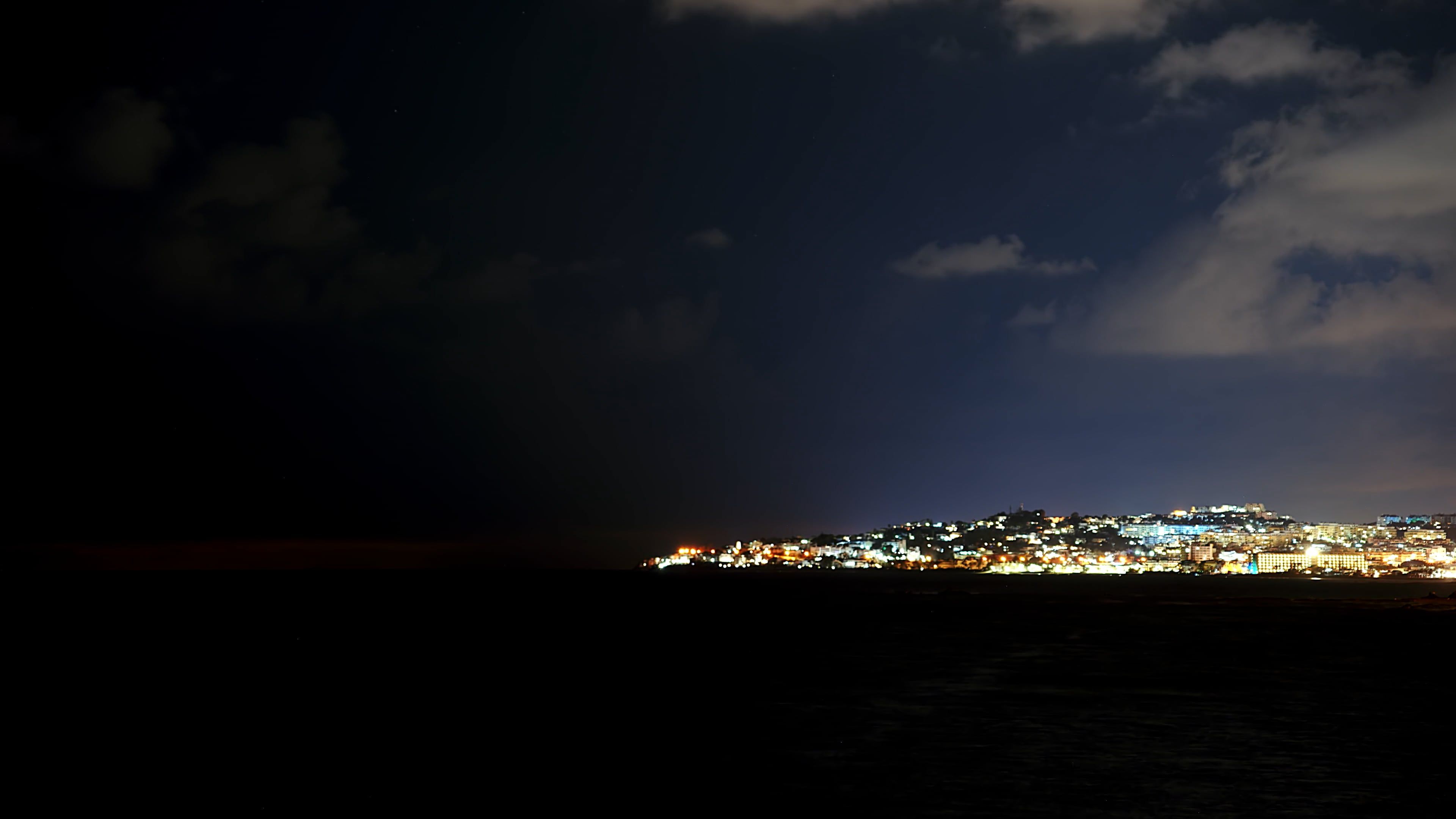 Time Lapse of Moving Clouds over a Coastal City at Night Free Stock ...