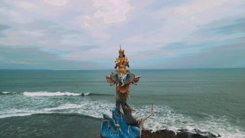 Statue of Hindu Deity against Vast Sea
