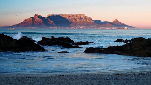 View of Table Mountain from a Rocky Beach at Sunrise