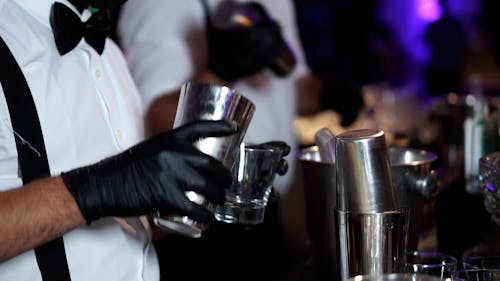 Bartenders Preparing and Serving Cocktails 