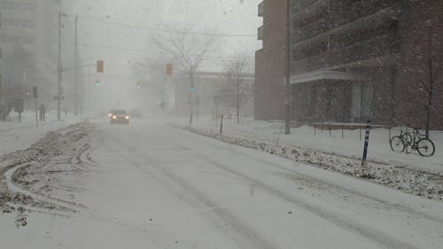 Cars and People in the Street during a Heavy Snowfall 