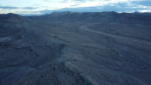 Drone Footage of Two People Hiking in an Arid Landscape