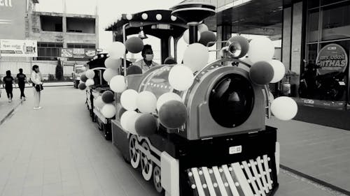 Black and White View of Train with Balloons