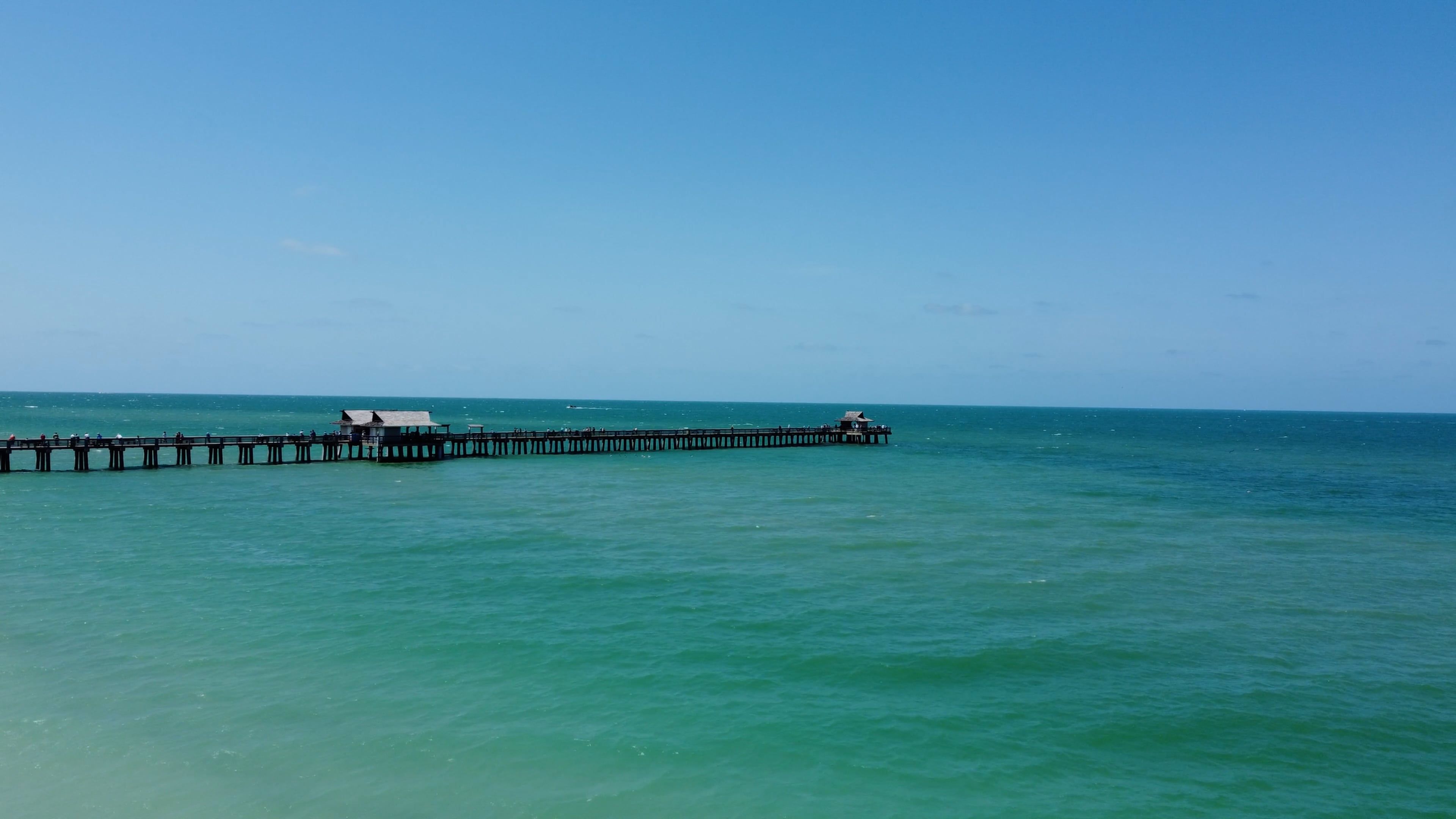 Naples Pier reaching into the Gulf of Mexico at Naples, Florida