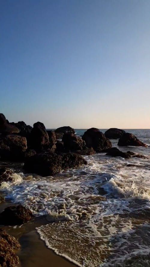 Waves Reaching the Shore of a Rocky Beach 