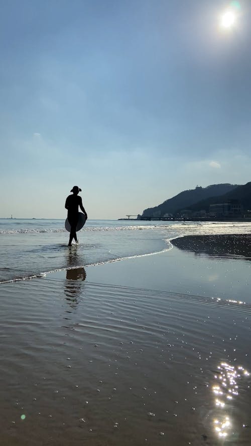 Surfers Surfing on the Beach