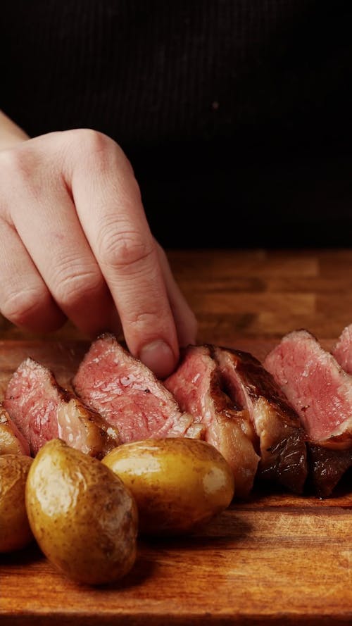 Close up on Hand Lifting Steak
