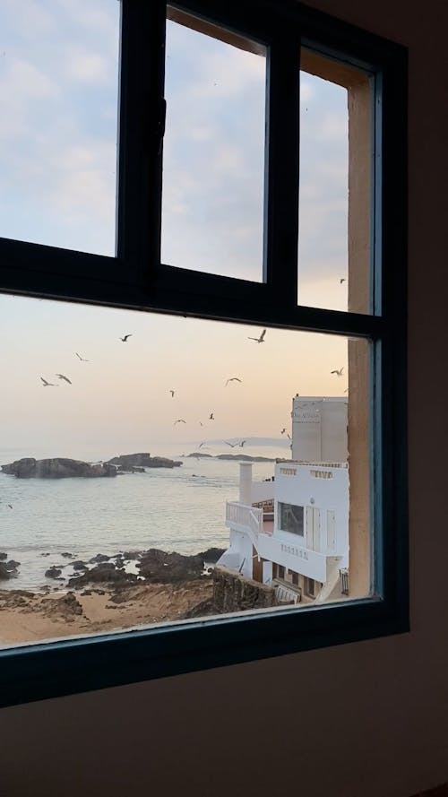 Window View of a House by the Sea 