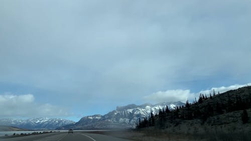 Point of View of a Car Driving on a Road in a Mountain Landscape 