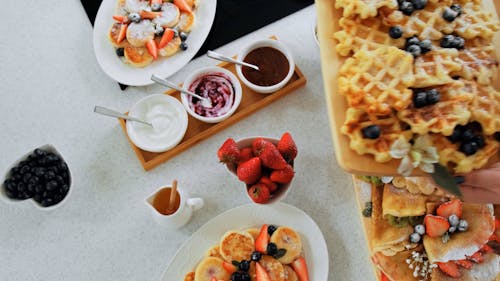 Hands Holding Food over Table