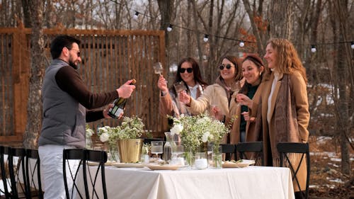 Man Pouring Wine for Women