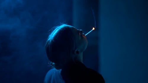Woman Smoking in Darkness