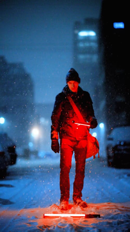 Man Bending Down to Pick up Red Flare